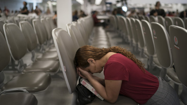 An evangelical kneels in prayer as she waits for pastor Silas Malafaia to speak at the Assembly of God Victory in Christ Church, in Rio de Janeiro.