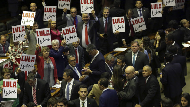 Opposition lawmakers hold "Free Lula " placards during the new House of Representatives inaugural ceremony in Brasilia last week.
