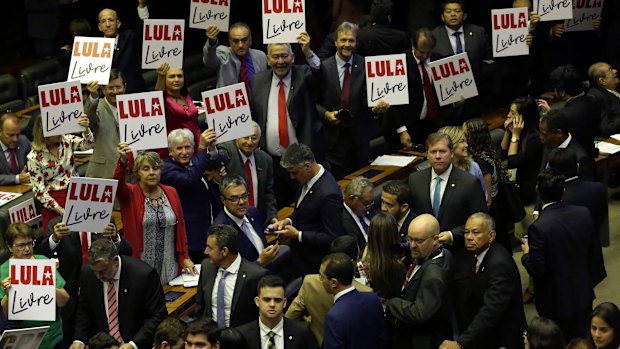 Opposition lawmakers hold "Free Lula " placards during the new House of Representatives inaugural ceremony in Brasilia last week.