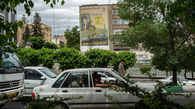 Commuters drive past a giant wall mural proclaiming the destruction of Israel in Tehran, Iran, on Wednesday.
