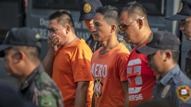 Suspects in the Ampatuan Massacre are escorted by policemen as they arrive for the verdict.