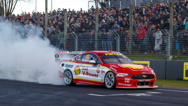 In a spin: Scott McLaughlin celebrates his record-breaking 17th win of the season in front of race fans.