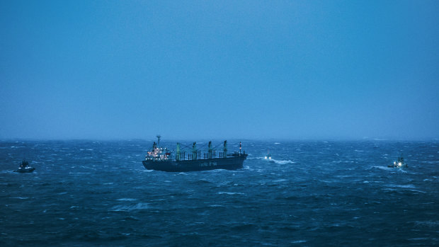 Three tugboats tow the MV Portland Bay to safety.