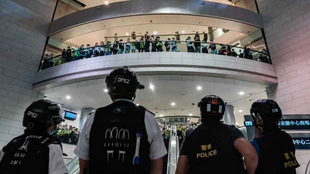 Hong Kong police face off against protesters in a shopping centre in April this year.