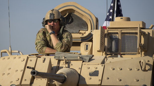 A US soldier looks out of a tank at an American base at undisclosed location in north-eastern Syria.