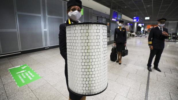 
A Lufthansa crew member holds a high-efficiency particulate air (HEPA) cabin filter as the airline and airport operator Fraport AG, showcase new coronavirus safety measures at Frankfurt Airport in Germany.