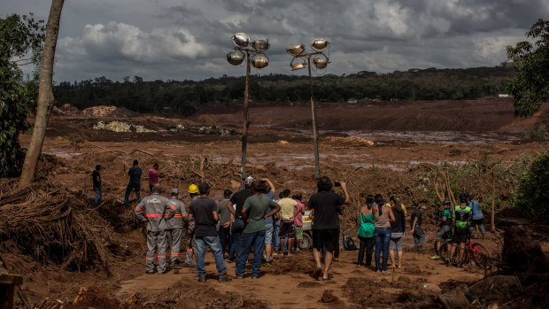 Residents survey damage after a Vale SA dam burst in Brumadinho, Brazil, on Saturday.