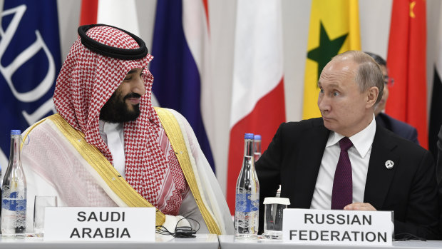 Saudi Arabia's Crown Prince Mohammed bin Salman, left, talks with Russian President Vladimir Putin, right, during the G-20 summit in Osaka, Japan, last year.