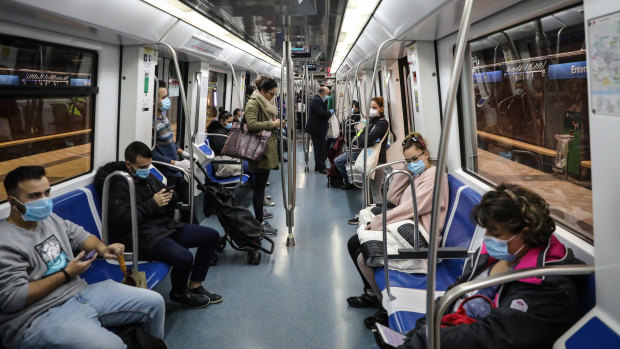 Commuters ride the metro in Barcelona on Tuesday.