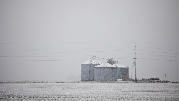 Snow falls on grain storage buildings in the Mid-west. 