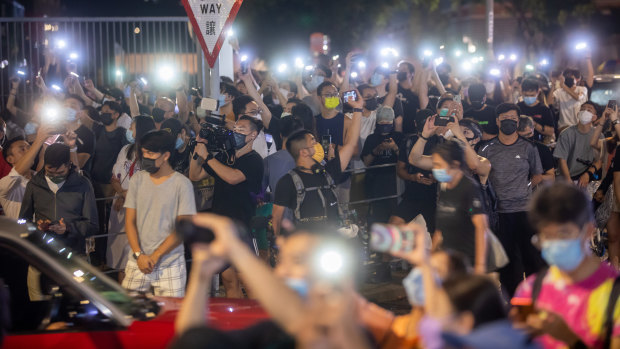 Supporters illuminate mobile phone torches outside the headquarters of the Apple Daily. 