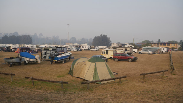 People camp out in an evacuation centre in Batemans Bay on January 04, 2020.  Super Retail Group, the owner of Macpac and Boating Camping Fishing,  has warned investors of a significant hit to sales due to the bushfires.
