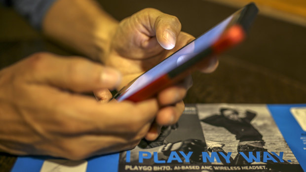 A man uses a smartphone in Mumbai, India.