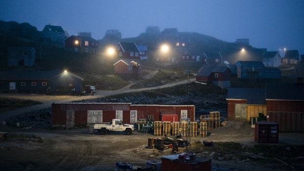 Early morning fog shrouds homes in Kulusuk, Greenland. As warmer temperatures cause the ice to retreat the Arctic region is taking on new geopolitical and economic importance.