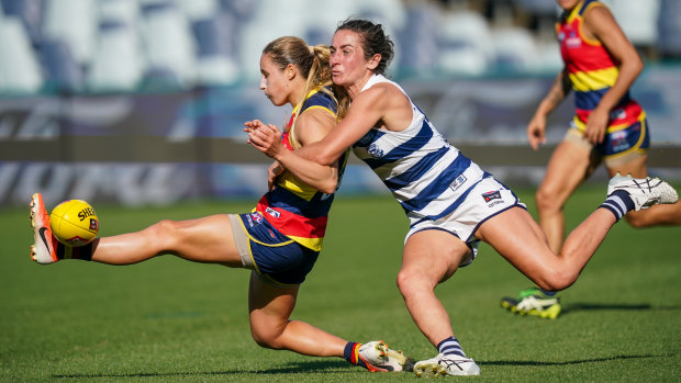Grounded: Crow Nikki Gore is caught as she attempts to kick away against the Cats at GMHBA Stadium on Sunday.