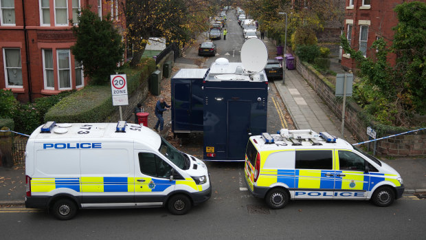 Police cars block a road during a search of an address connected to investigations into the explosion outside Liverpool Women’s Hospital, England.