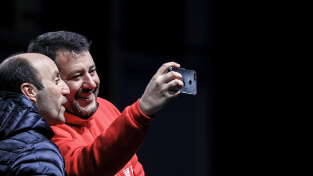 Matteo Salvini, leader of the League party, takes a selfie photograph with an attendee during a campaign rally in Maranello, Italy.