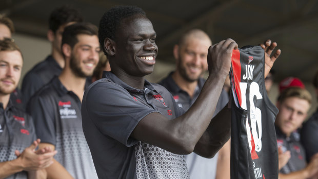 Tom Jok receiving the No.46 guernsey at the Essendon Football Club family day in December. 