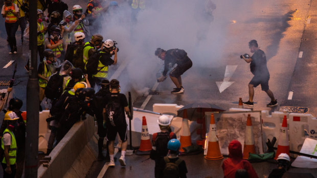 Riot police deploy tear-gas during the protests.