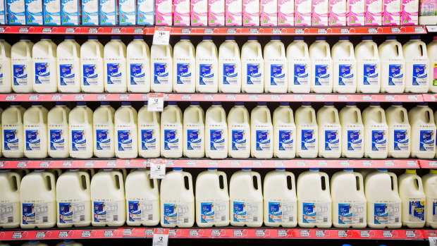 Fresh milk products are displayed at a Coles supermarket.
