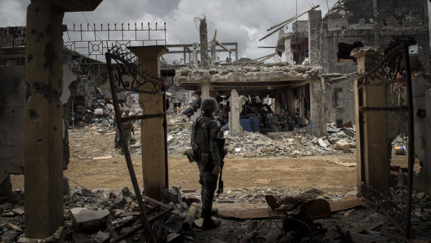Military officials in the Philippines are blaming a spate of recent bombings on the Bangsamoro Islamic Freedom Fighters, a small but hard-line group that has aligned itself with the Islamic State group. In this photo, a soldier stands amid ruined buildings after months of fighting in Marawi against Islamic State-inspired militants.