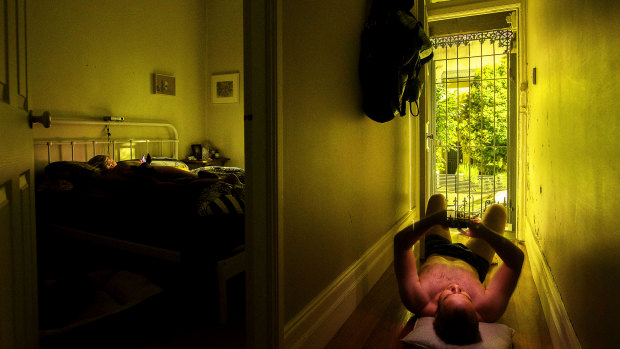 Christopher Pearce has resorted to lying on the floorboards of his home, in Sydney's Newtown, to beat the heat.