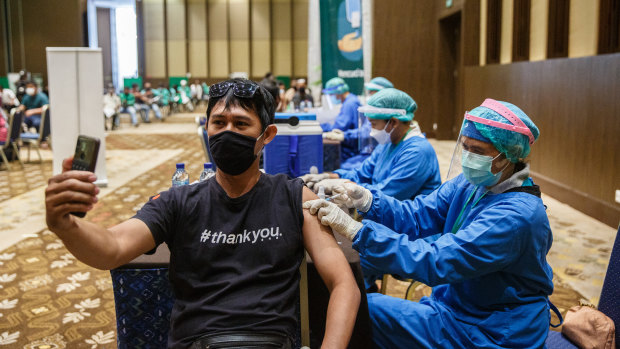 A healthcare worker is injected with the vaccine in Bali.