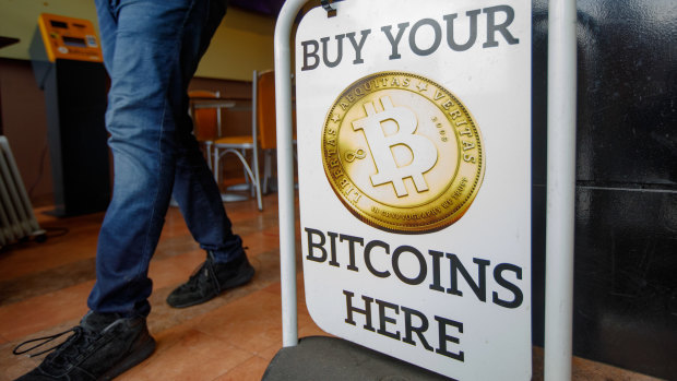 A sign advertising a bitcoin automated teller machine at a cafe in London.