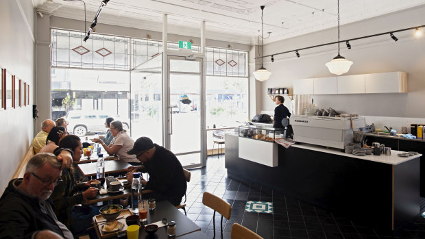 Kurumac's dove-grey walls, stained-glass windows, and soft raw wood tables provide a calming atmosphere in this Japanese-Australian cafe. 