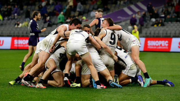 Newnes is mobbed after kicking the winning goal. 