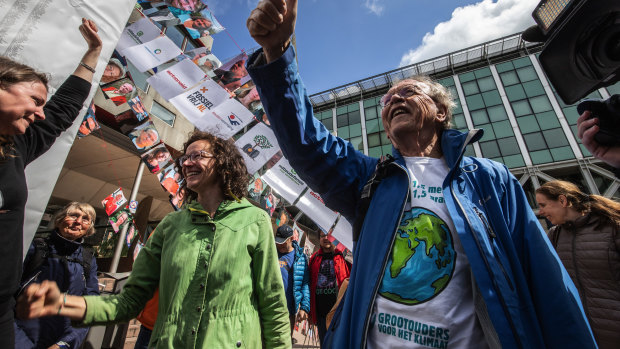 Environmental activists celbrate the verdict in the case against Shell in the Hague.