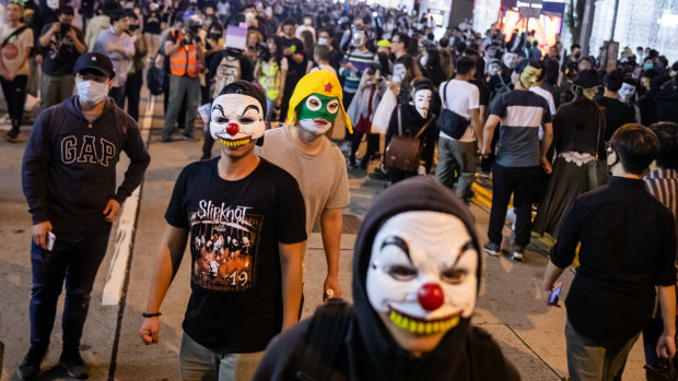 Hong Kong residents wore Halloween masks in defiance of a recent law.