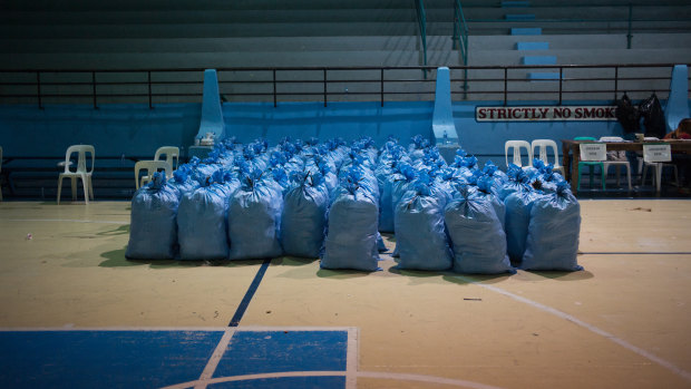Sacks filled with relief goods sit in a gym awaiting distribution to temporary evacuation centers ahead of Mangkhut's arrival in Tuguegarao n Friday.