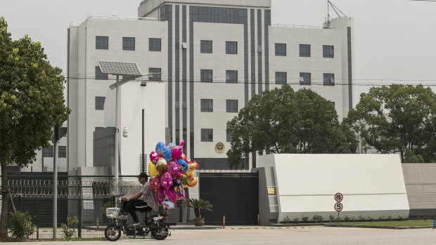 A man selling balloons ride his scooter past Qingpu Prison, where Australian citizen and former Rio Tinto executive Stern Hu was held, in Shanghai.