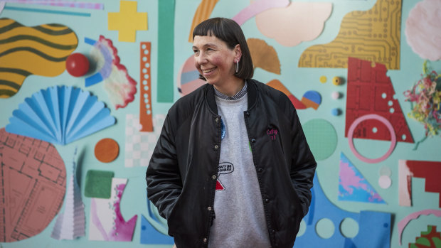 Artist Beci Orpin in front of her mural commissioned by the Metro Tunnel Project.