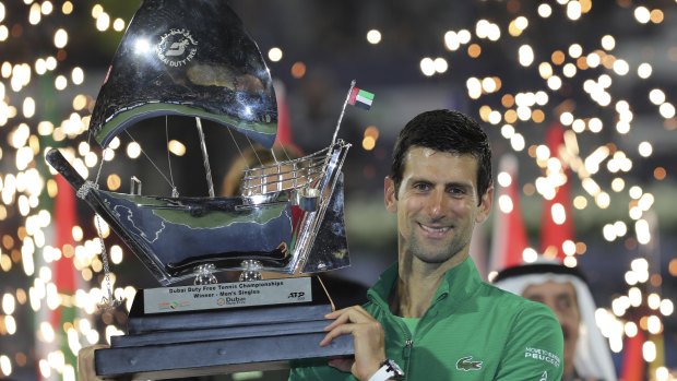 Serbia's Novak Djokovic enjoys the spoils after beating Stefanos Tsitsipas in the Dubai final.