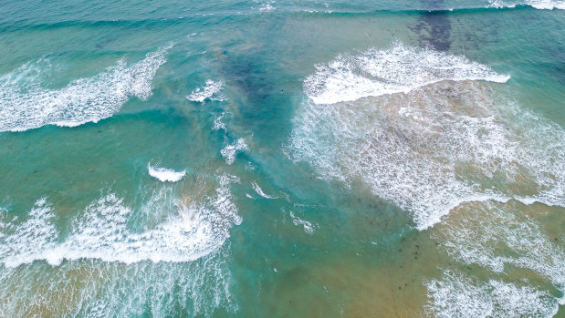 The rip is the dark water between the waves and the sandbanks.