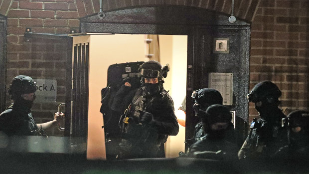 Armed police officers at a block of flats off Basingstoke Road in Reading after an incident at Forbury Gardens.