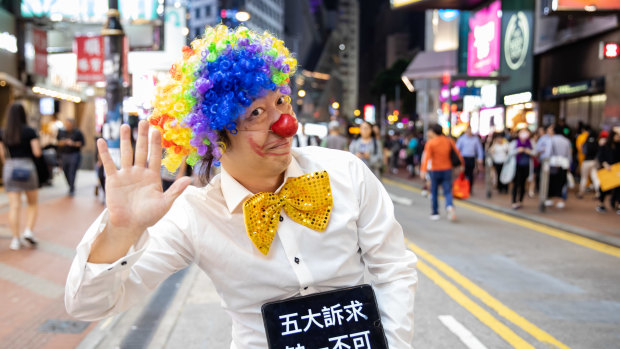 A 'Halloween' protester in a clown costume stands for a photograph in the Causeway Bay district of Hong Kong, China.