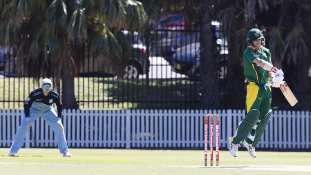 David Warner evades a bouncer as Steve Smith waits in the slips. 