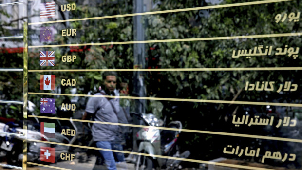 Various currencies are displayed on a money exchange bureau window in downtown Tehran.
