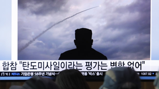 People watch a TV showing an image of North Korea's a multiple rocket launch during a news program at the Seoul Railway Station in Seoul, South Korea.