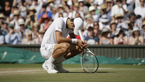 Relief: Novak Djokovic drops to his haunches after winning the title.