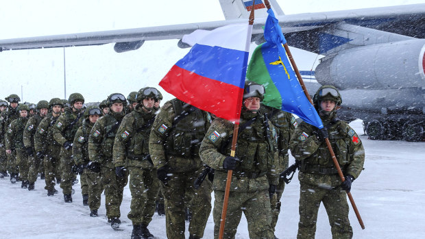 Russian soldiers leave a Russian military plane during the withdrawal of its troops, at an airport outside Moscow.