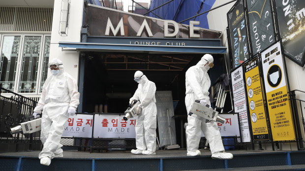 Workers spray disinfectant in Seoul.