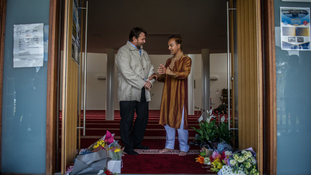 Christchurch man Paul Bradley speaks to Canberra Muslim Community president Mainul Haque at Gungahlin Mosque on Saturday.