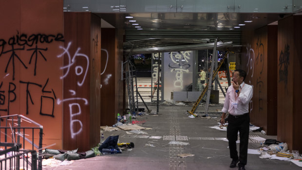 A member of staff walks past graffiti covered walls during a media tour inside Legislative Council building in Hong Kong,.