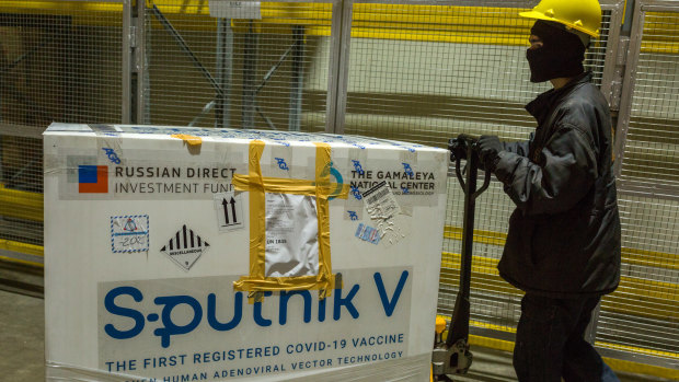 A worker uses a pallet trolley to transport a crate of the Sputnik V COVID-19 vaccine at a cold storage facility in Karachi, Pakistan.