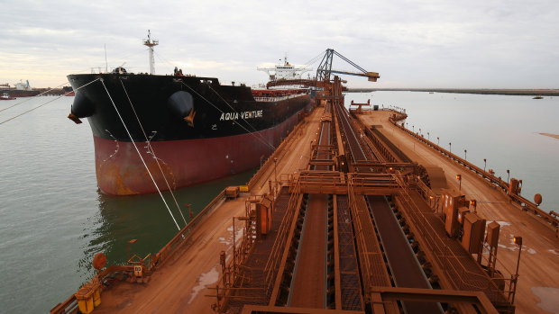 A ship takes on iron ore at Port Hedland.
