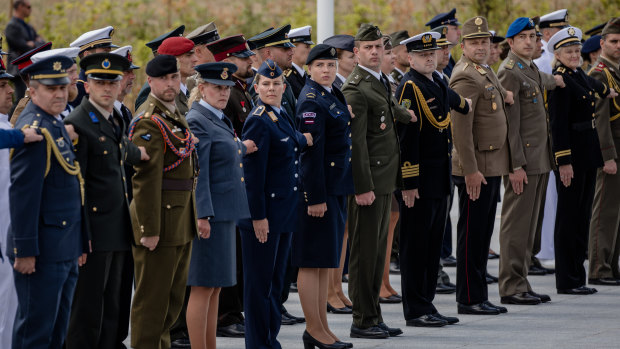 Military personnel from member states stand to attention during the NATO summit in Brussels on Wednesday.